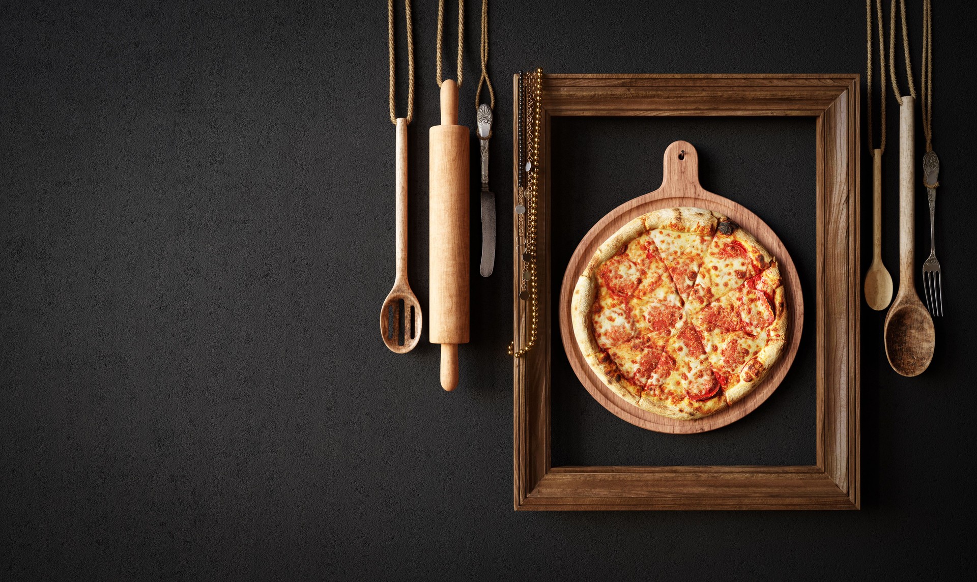 Hot pizza slice with kitchen tools and frame