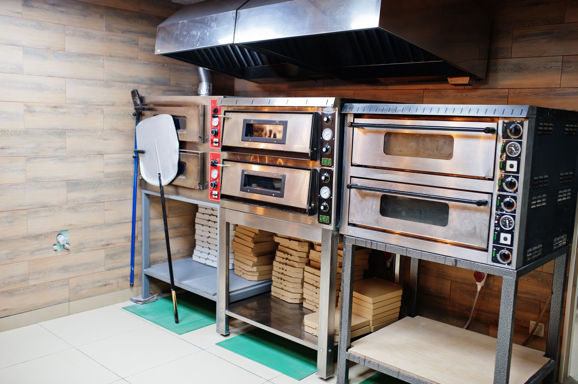 Traditional italian pizza. Long irob shovel for pizza against professional oven.