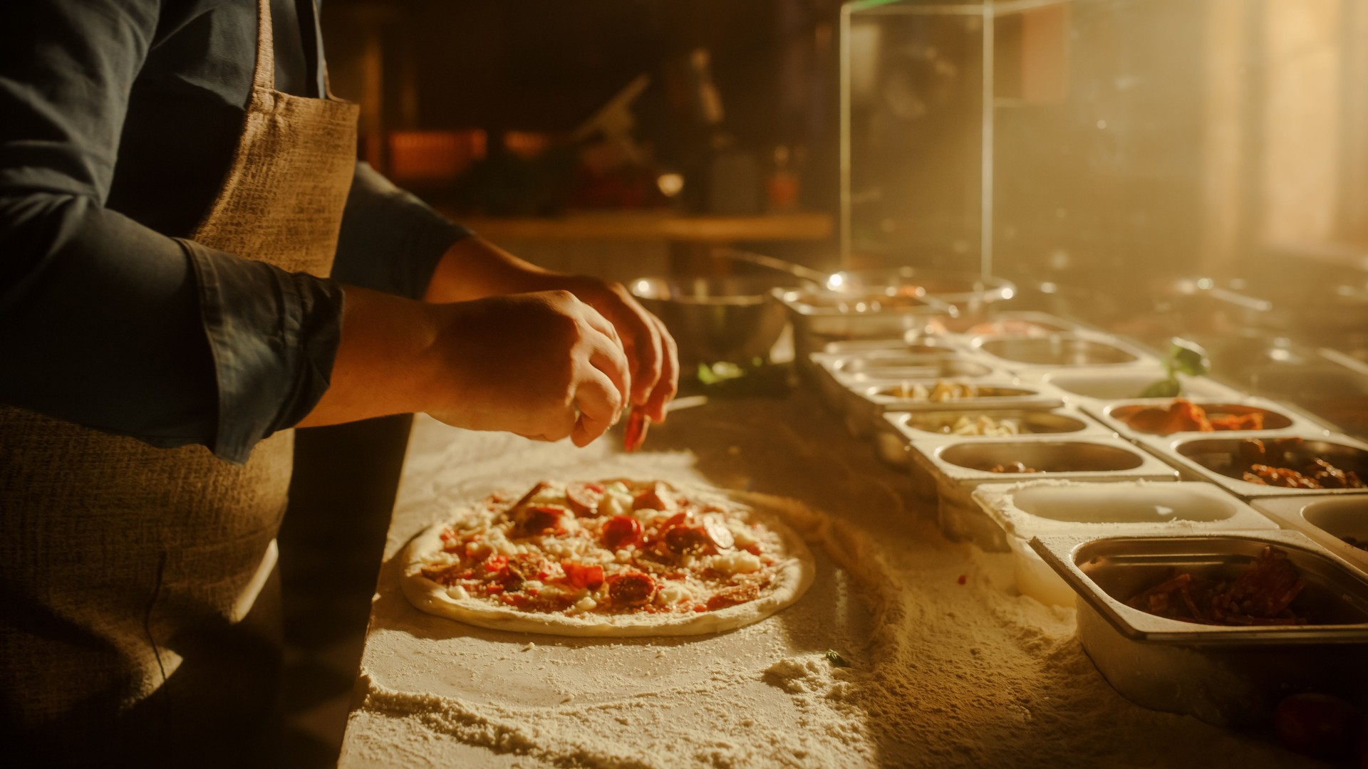 In Restaurant Professional Chef Preparing Pizza, Kneading Dough, Adding Ingredients, Special Sauce, Traditional Family Recipe. Authentic Italian Pizzeria with Delicious Organic Food. Focus on Hands